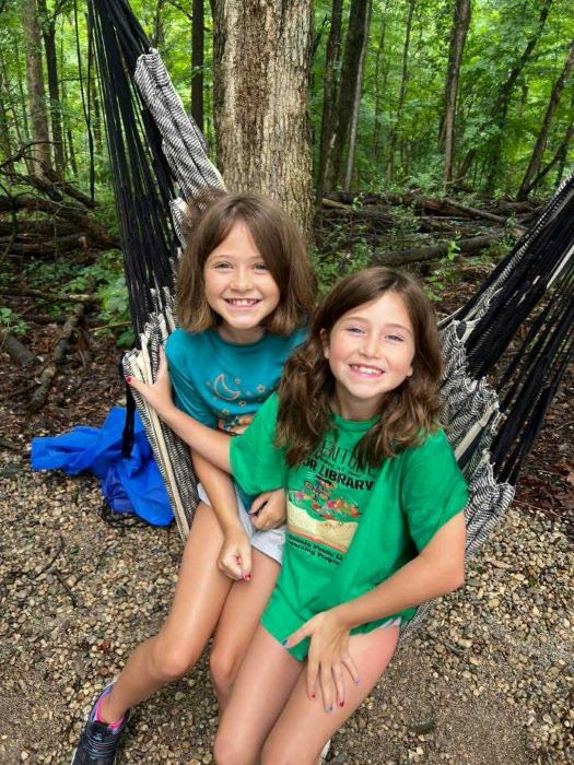Two campers in a hammock.