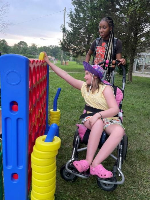 Campers playing a jumbo tabletop game.