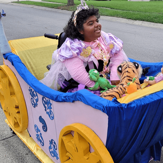 Morgan rides in her Princess carriage.