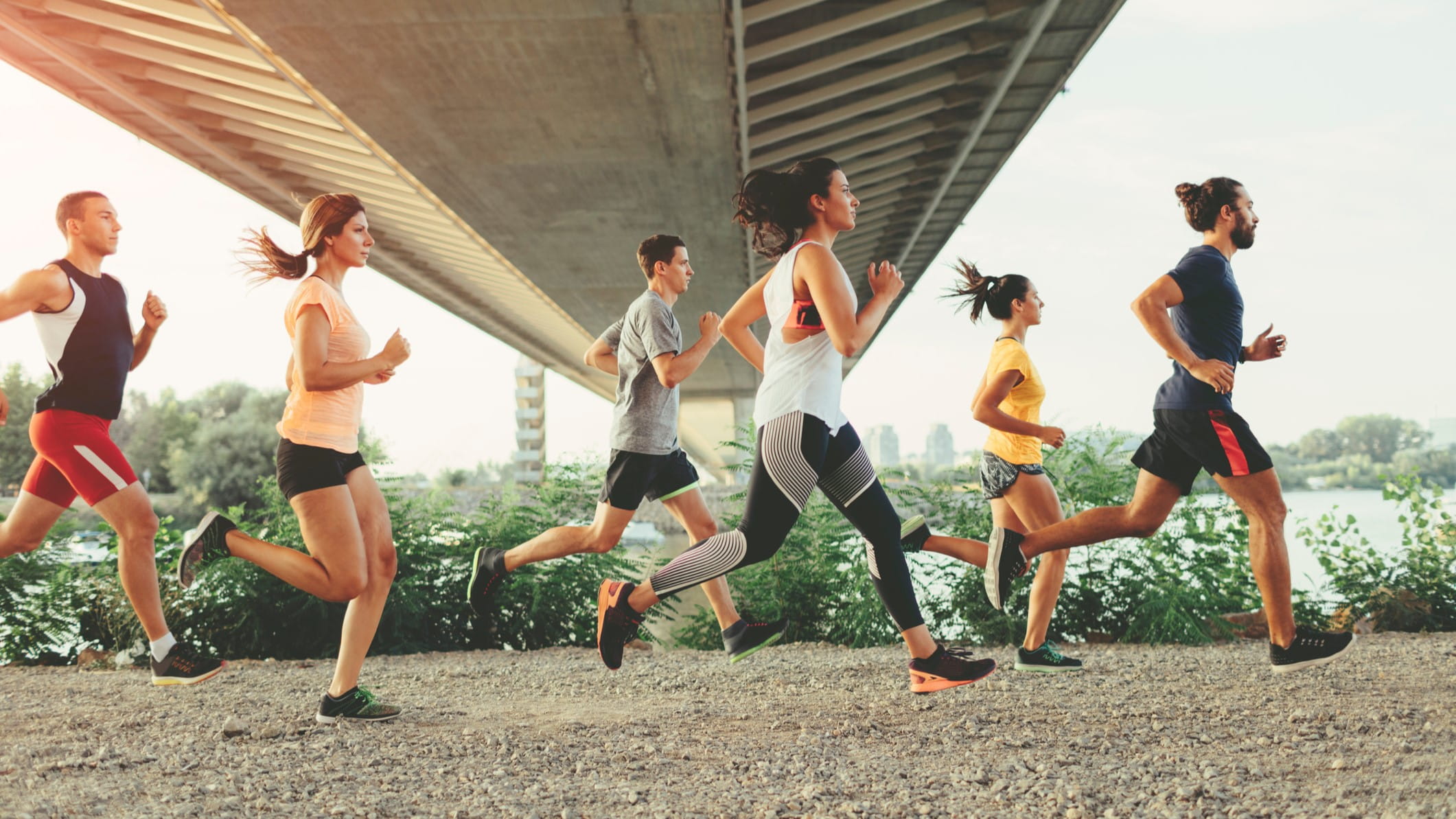 A group of runners under a bridge.