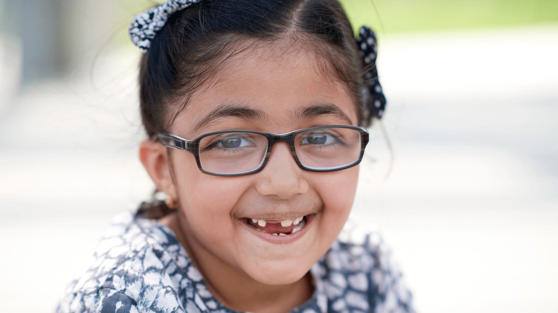 A young girl smiling.