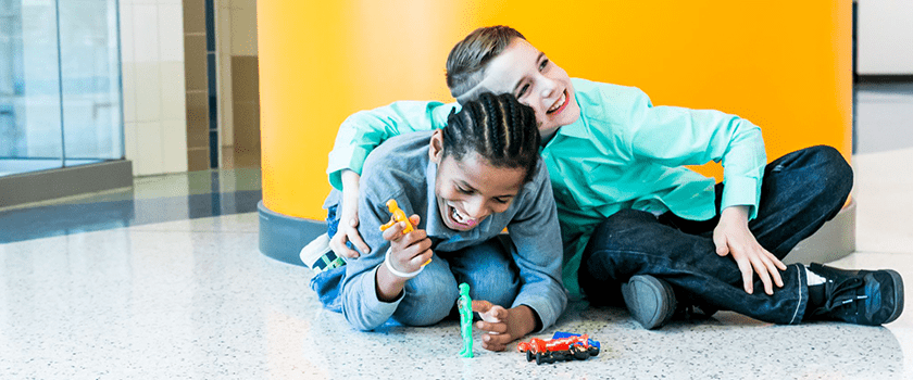 Two cerebral palsy patients and best friends playing and laughing.