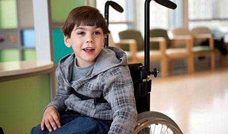 Patient in his wheelchair at the Cerebral Palsy Clinic.