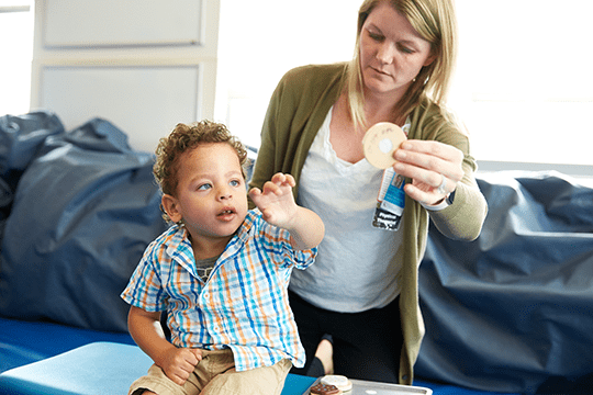 Cerebral palsy patient working with physical therapist on mobility training.
