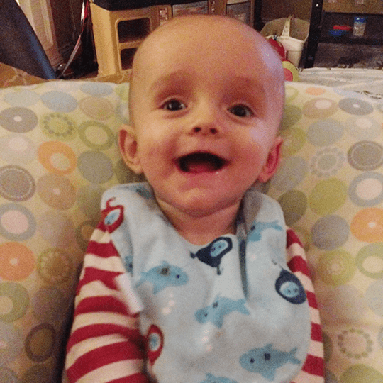 Baby Logan smiles.