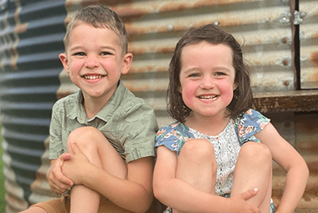 Austin and his sister smile.