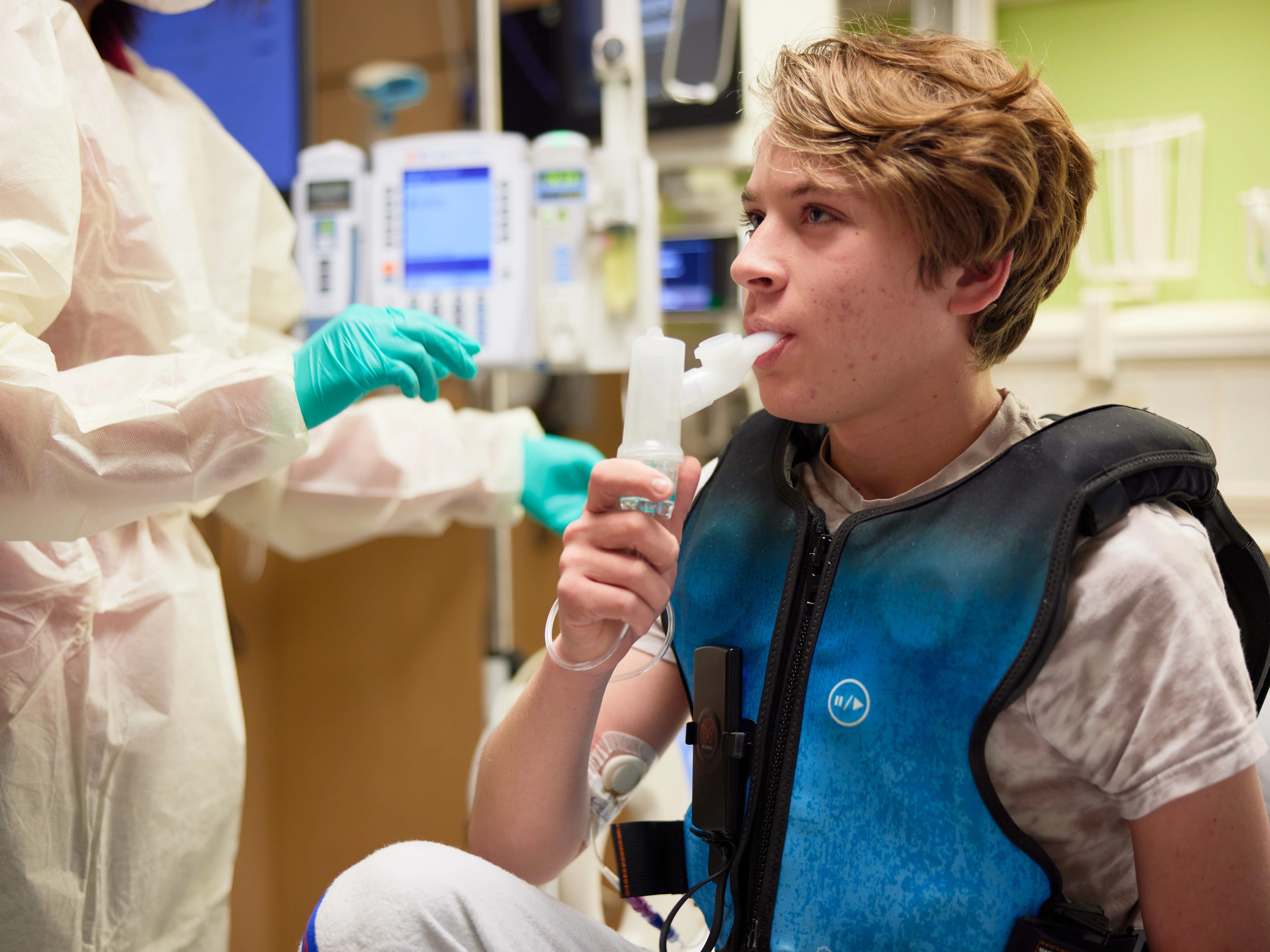 A respiratory therapist checking on a patient.
