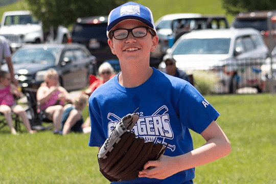 Aiden baseball smiling.