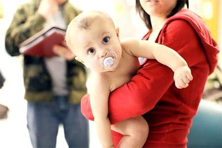 Addyson being held by her mother.