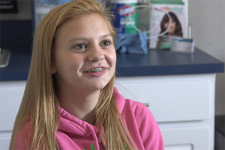 Lexus Kline, telehealth patient, smiling.