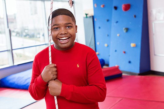 An image of a Developmental and Behavioral Pediatrics patient smiling.