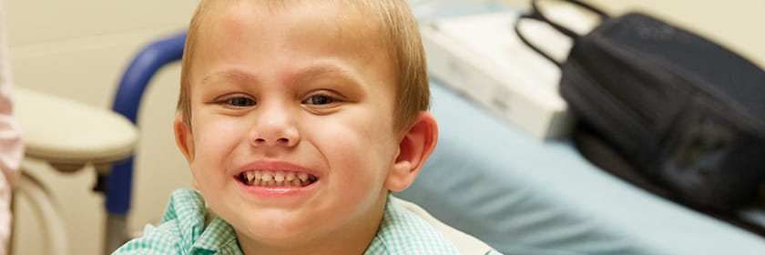 Boy smiles.