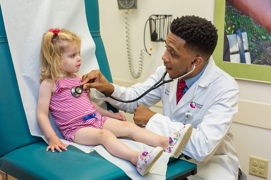Doctor doing a check up with young patient.