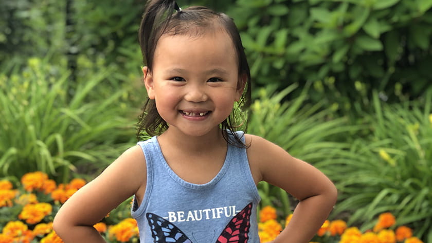 A photo of Elena Philippe standing proud, smiling.