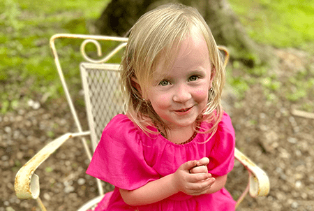 Everly sits and smiles. 