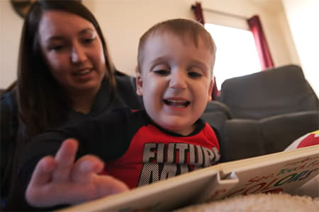 Jaxyn reading with his mom.