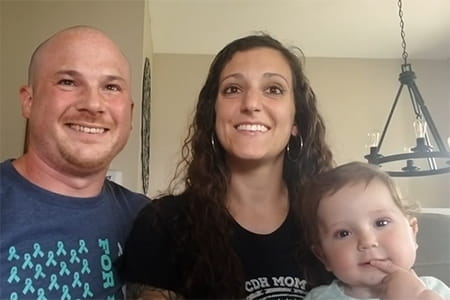 Mila with her parents.