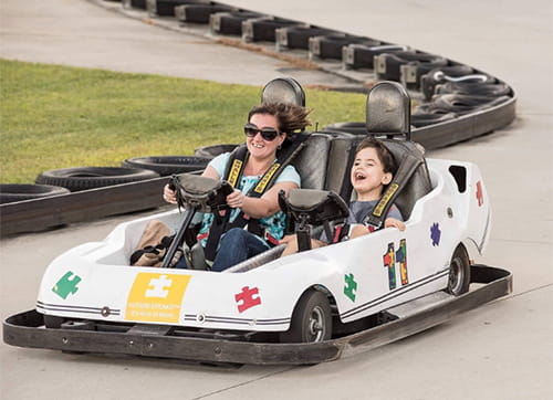 William Hileman and mom driving racecar.