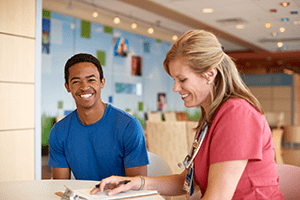 A photo of two people laughing.