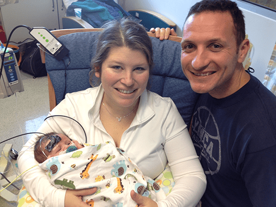 Tom and Kat hold baby Harding.