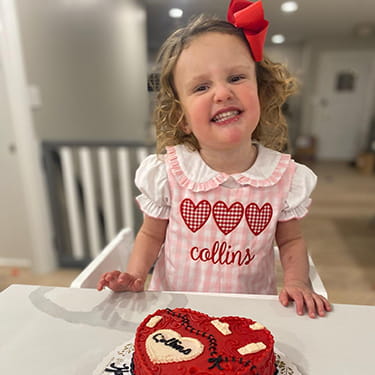 An image of Collins Hawkins, Cincinnati Children's heart patient, smiling with her cake.