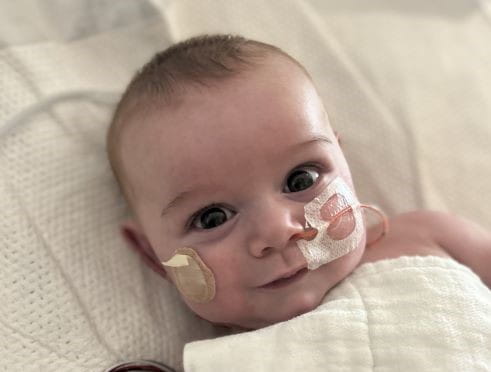Heart surgery patient, David, smiles at the camera.