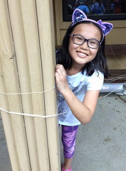 Olivia smiles at summer camp. 