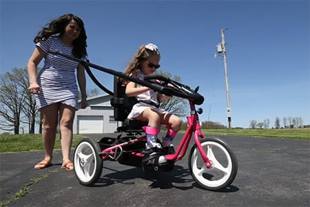 Michaela riding her bike with her mom.