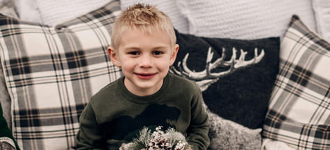 Trey smiles on couch.