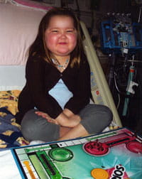 Hannah at Cincinnati Children's with board games provided by Child Life Services.