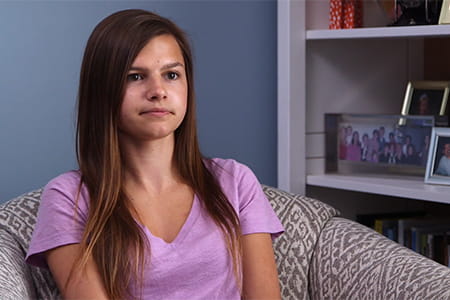 IBD patient sitting on a couch.