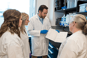 A researcher in infectious diseases and his students.
