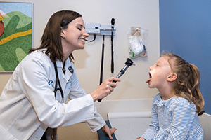 A infectious diseases doctor examines her patient.
