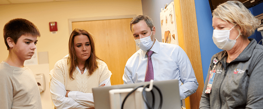 Interventional endoscopy providers discussing treatment with a patient.