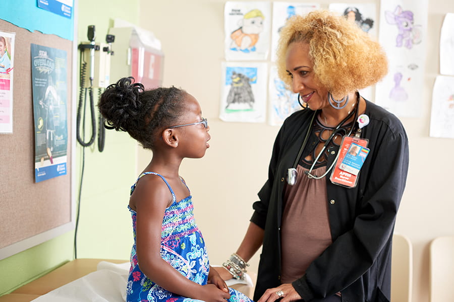 A nurse with a young female patient.