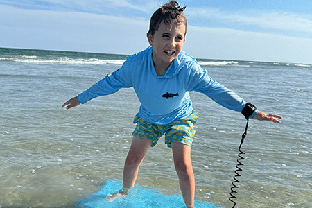 Boden rides a boogie board.