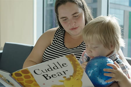 Logan reading with his mom.