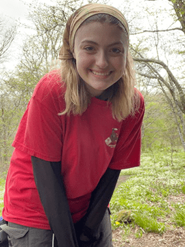 Olivia smiles while on a hike.