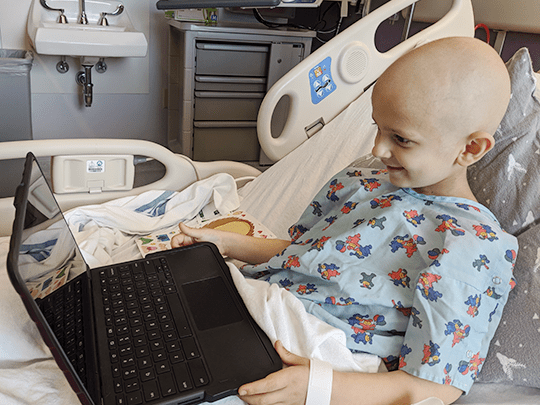 Noah visits his classmates online while in the hospital.