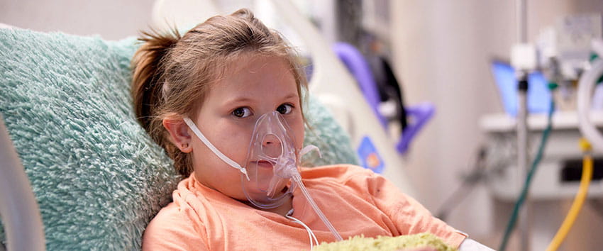 Female patient wearing an oxygen mask.