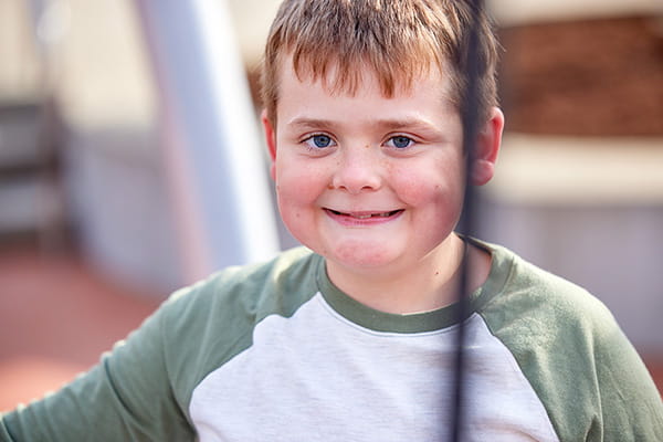 A photo of a child smiling.