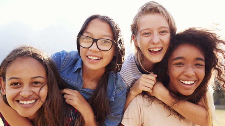 A group of teenage girls smiling.