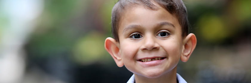 Nephrology patient smiling while playing outside.