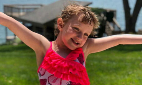 Vivian smiles in her swimsuit.