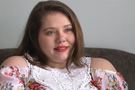 Megan sitting on a couch.