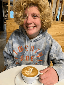 Zoe enjoys a cup of coffee.