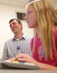 A girl works on a computer. 