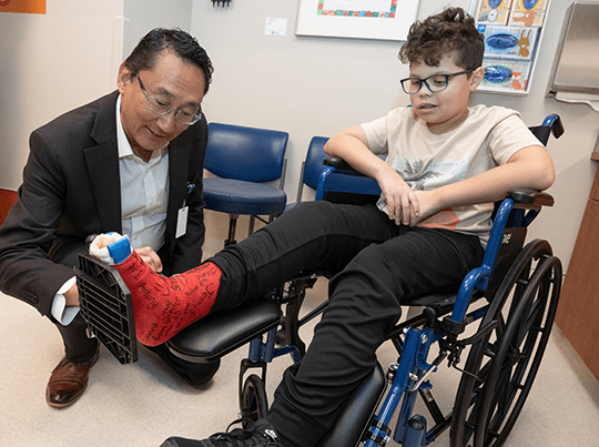Dr. Choo signs Ezra's cast.