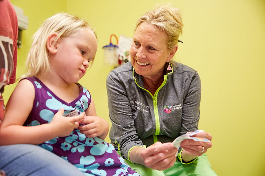 Smiling nurse with young patient.