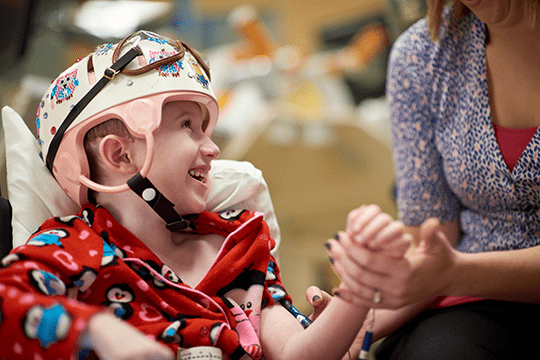 A patient smiling while working with a clinician.